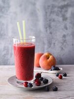 A watermelon and blueberry smoothie with gooseberries and peaches