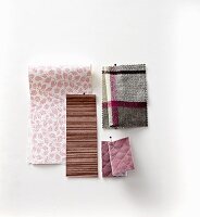 Pinned fabric and wallpaper swatches in purple tones