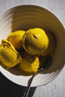 Curry ice cream in a bowl with a spoon