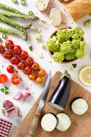 An arrangement of fresh vegetables and bread (seen from above)