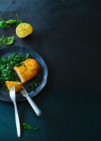 Turkey escalope in a coconut coating on spinach (Paleo)