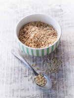 Natural rice in a porcelain bowl and on a spoon