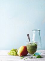 A green smoothie with fruit and wild herbs