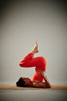 Shoulder stand (Sarvangasana) – Step 1: raise legs up supporting your pelvis
