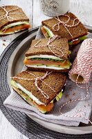 Schwarzbrot-Sandwiches mit Ziegenkäse, Räucherlachs und Avocado
