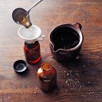 Horehound wine (à la Hildegard von Bingen) being poured into an apothecary bottle