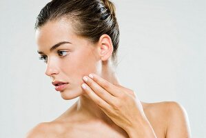 A young woman performing skincare