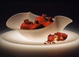 Pomegranates in a white glass bowl