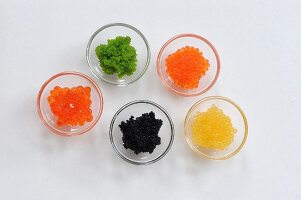 Various types of caviar in glass bowls