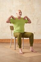 Rumpfdrehen (Yoga), Schritt 1: Sitzen, Hände auf Schultern