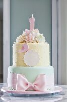 A festively decorated birthday cake in delicate pastel tones