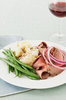 Flank steak with pickled onions, mashed potato and green beans