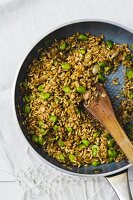 Oat salad with fava beans in a pan (seen from above)