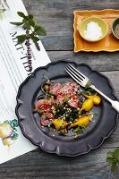 Beef with red and yellow beetroot, capers and herbs