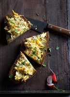 A slice of bread topped with turnip, radishes and carrots