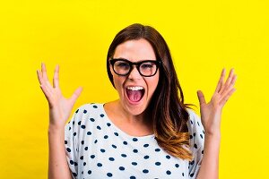 A screaming woman wearing glasses and a polka-dot t-shirt