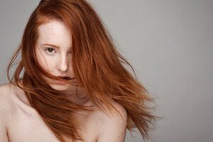 A portrait of a young woman with red hair