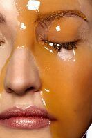 Honey flowing over a woman's face