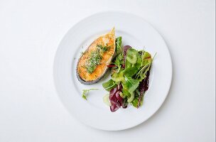 Salmon steak with herb salt and a mixed leaf salad