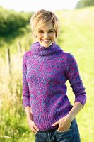 Young, blonde woman wearing colourful roll-neck jumper