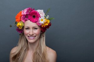A young blonde woman with a colourful flower wreath on her head