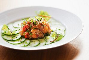 Korean-style salmon tartare with slices of cucumber