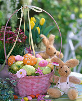 Pink handle basket with Easter eggs and flowers