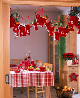 Advent calendar of red, filled bags with child