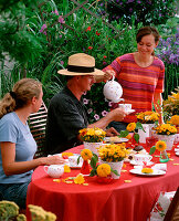 Summer coffee table in the garden with people