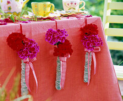 Wrapped glass tubes as vases on the tablecloth