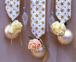 Dianthus (carnations), Rosa (roses), Pinus (pine) in white Christmas tree balls