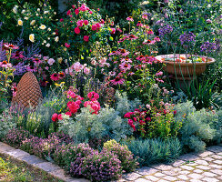 Pink-red bed with herbs and perennials