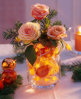 Arrangement of roses in fairy lights