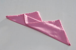 Napkins folding as a bishop's cap