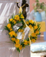 Heart-shaped taraxacum and grasses wreath on doorknob, sign