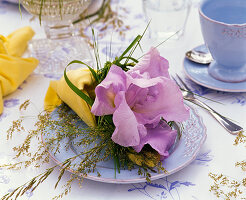 Napkin decoration with blue iris and grasses