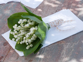 Small Convallaria (lily of the valley) bouquet in a sleeve