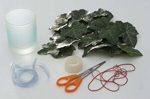 Glass decorated with ivy leaves as a vase