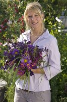 Young woman with bouquet of Callistephus (Summer Aster), Erigeron