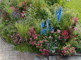 Bed with perennials, summer flowers and grasses