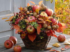 Autumn bouquet with apples, nuts, leaves and hydrangea
