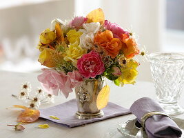 Autumn rose bouquet with clematis fruit and autumn leaves