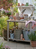 Pot table with clay pots, coasters, small appliances, potsherds and gravel