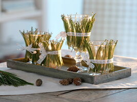 Unusual Advent wreath made of glasses decorated with pine needles