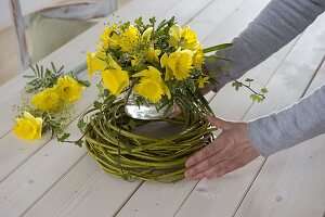 Yellow daffodil bouquet in wreath of dogwood branches