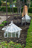 WOODPECKERS, WARWICKSHIRE, Winter: Old FASHIONED CLOCHES IN THE VEGETABLE Garden IN Winter