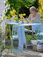 Yellow spring table decoration on the terrace