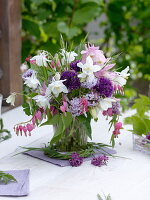 Spring bouquet from Aquilegia, Allium, Dicentra