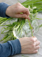 Glass covered with grass as a vase