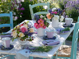 Summer table decoration with roses, lavender and raspberries